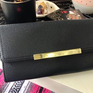 Black clutch with gold accents.